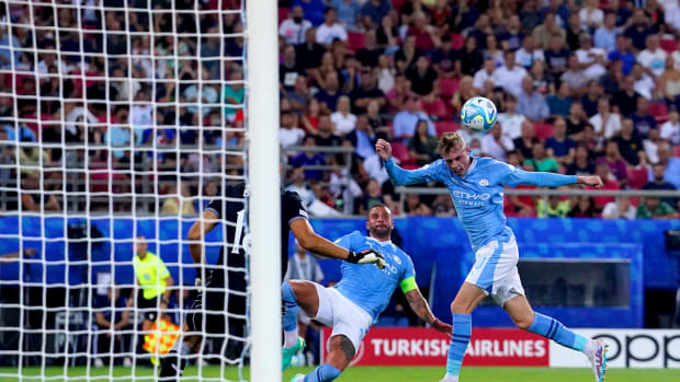 Cole Palmer pictured (right) heading the ball to score for Manchester City in the 2023 UEFA Super Cup final